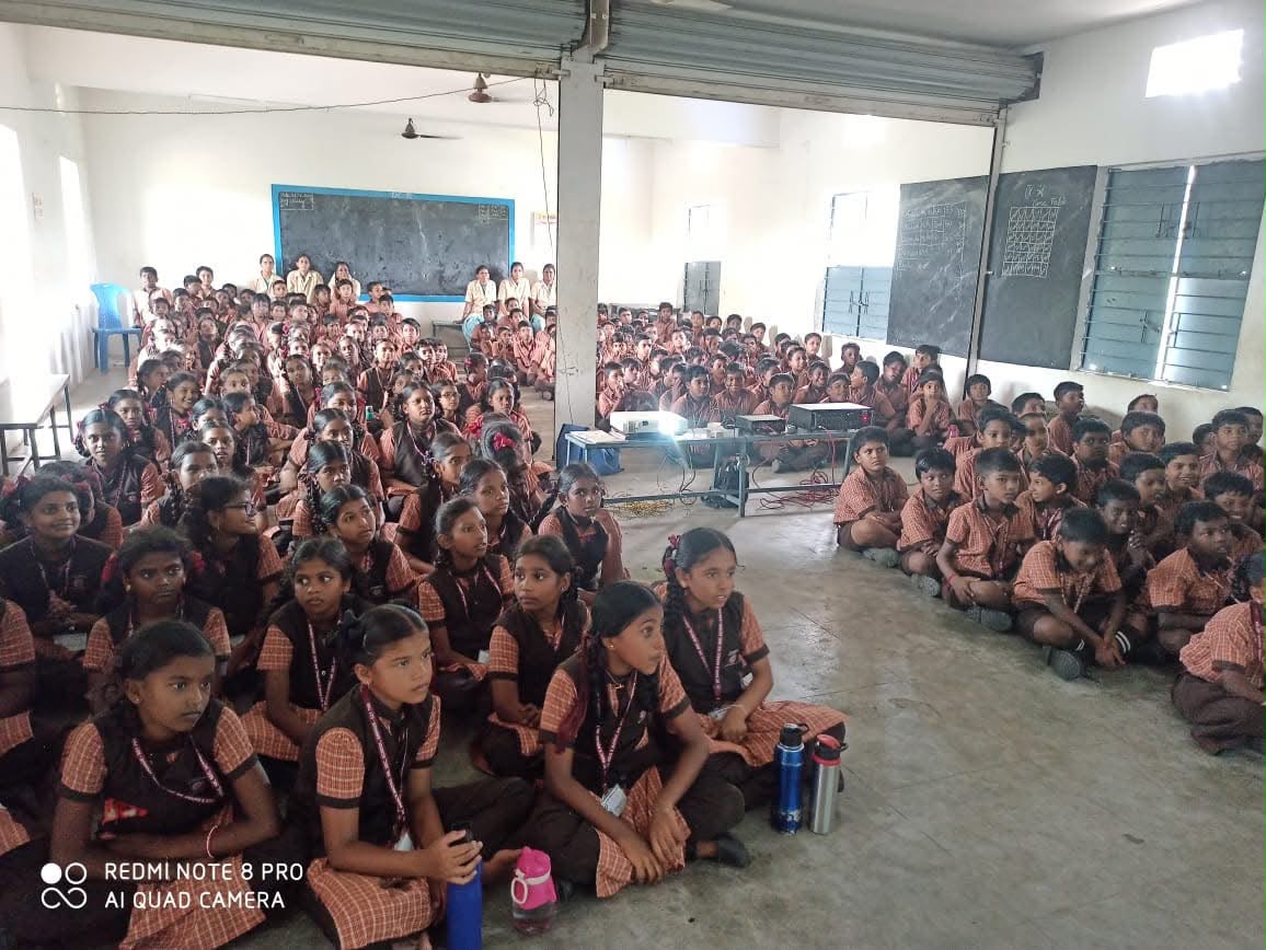 Primary students watching an educational presentation projected in the assembly hall