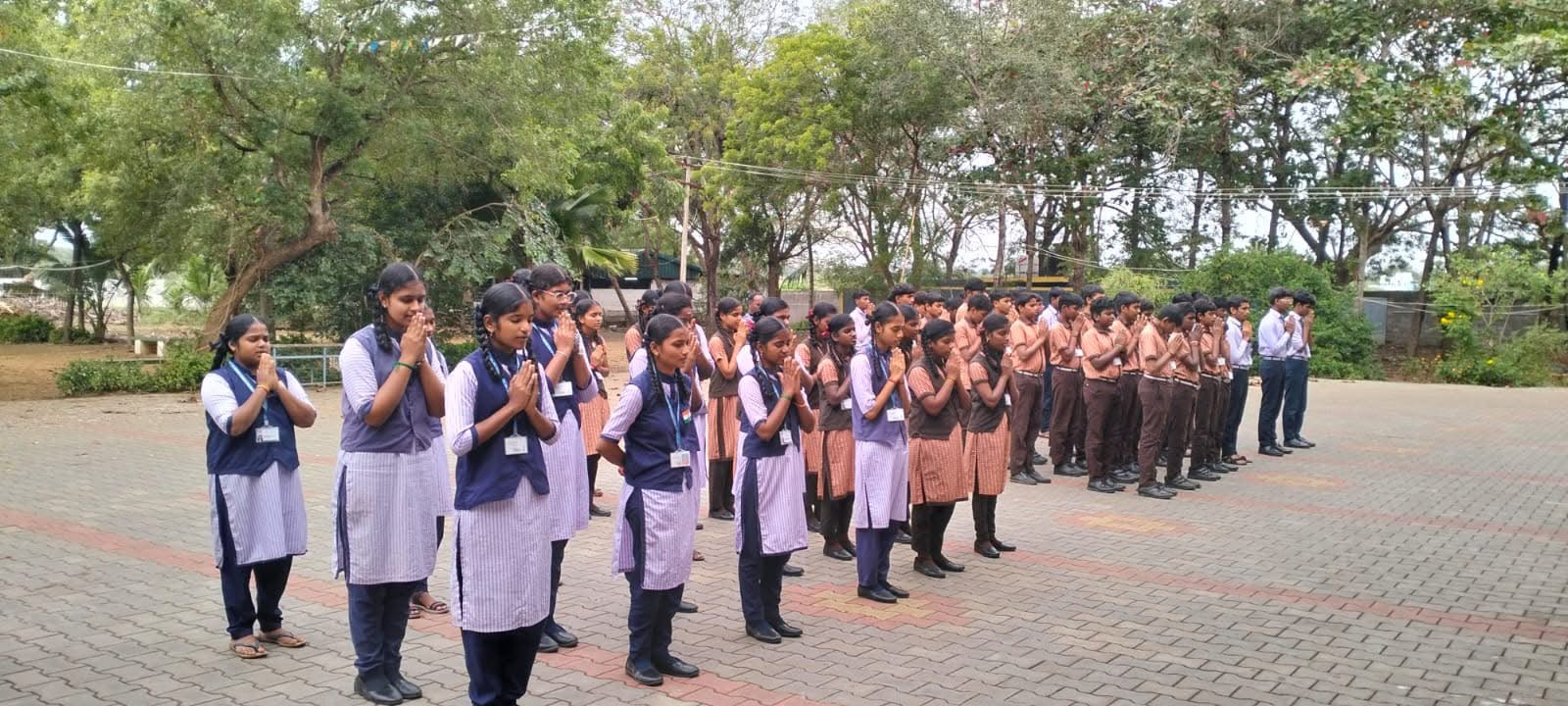 Senior students in morning prayer at the outdoor assembly ground