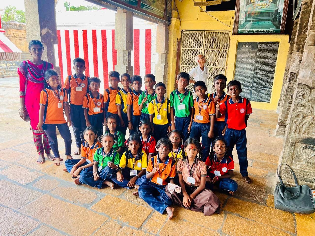 Primary students with their class teacher visiting a historic Tamil Nadu temple