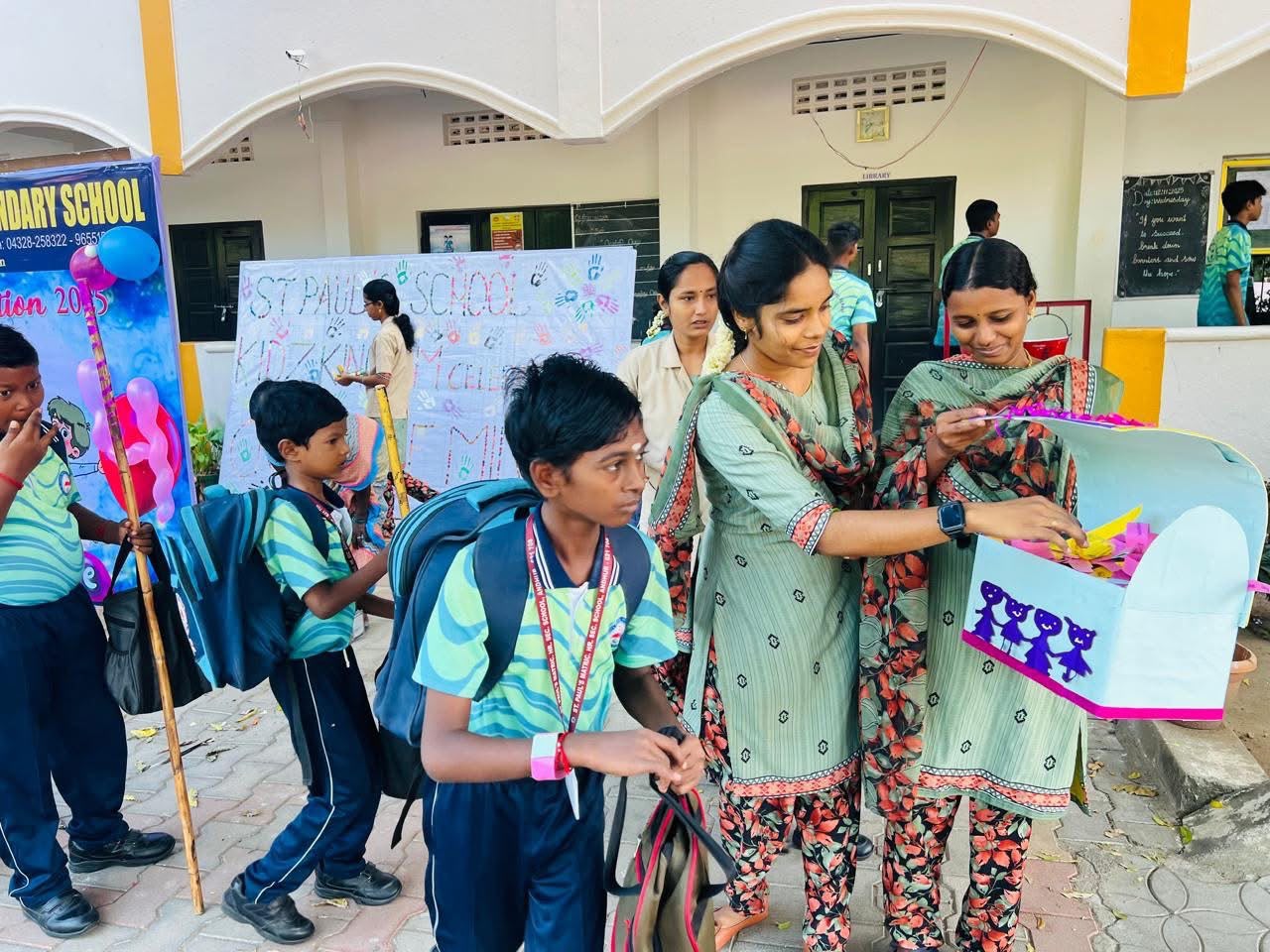 Students and teachers gathered for a class project outside the library