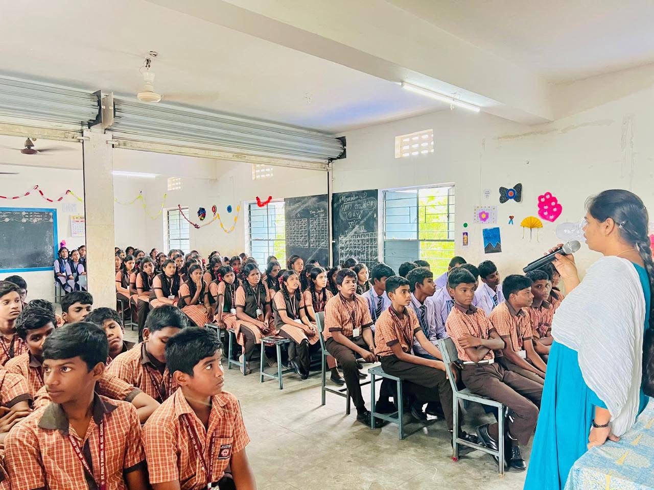 Teacher addressing senior students inside a classroom on Childrens Day